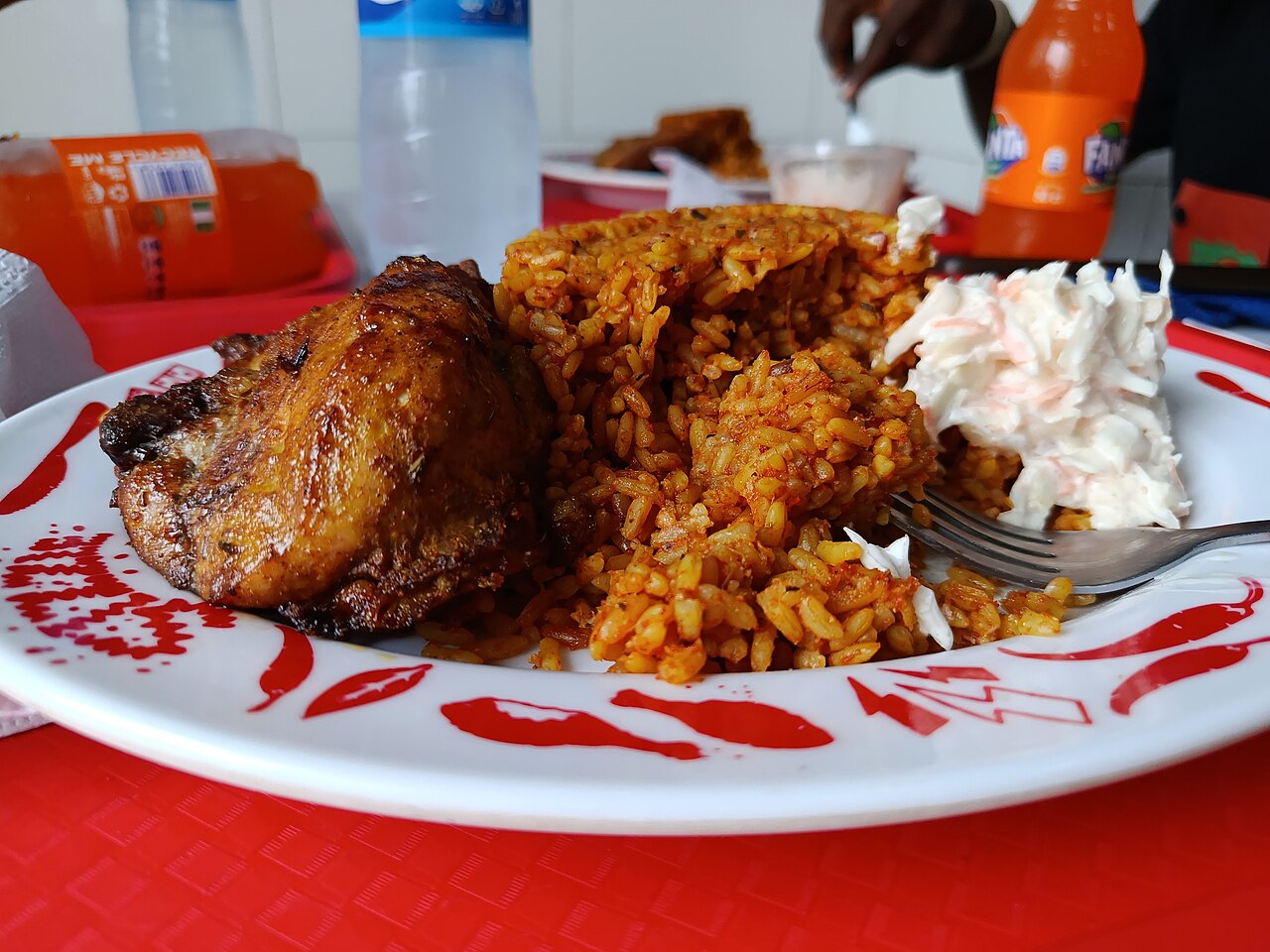 Photoreal photograph of the finished dish Nigerian jollof (Jollof), the actual plate from Nigeria, handmade ceramic, natural window light, shallow depth of field, no text, no logo, no people, Natural window light, ivory linen, handmade ceramic, shallow depth of field, no text, no logo, no watermark, fine-dining magazine photograph. Nigerian jollof