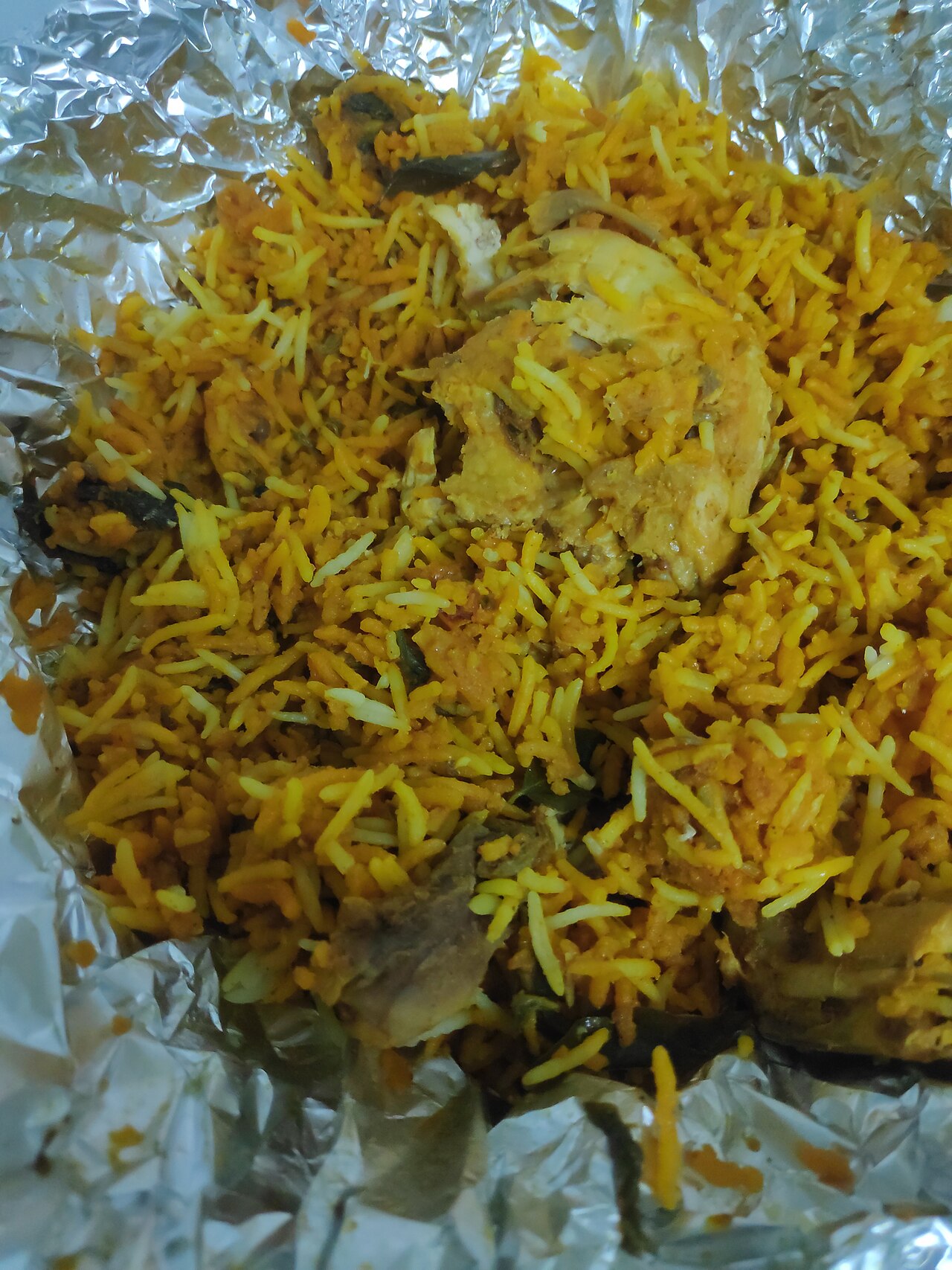 Photoreal photograph of the finished dish Chicken biryani (بریانی), the actual plate from Pakistan, handmade ceramic, natural window light, shallow depth of field, no text, no logo, no people, Natural window light, ivory linen, handmade ceramic, shallow depth of field, no text, no logo, no watermark, fine-dining magazine photograph. Chicken biryani