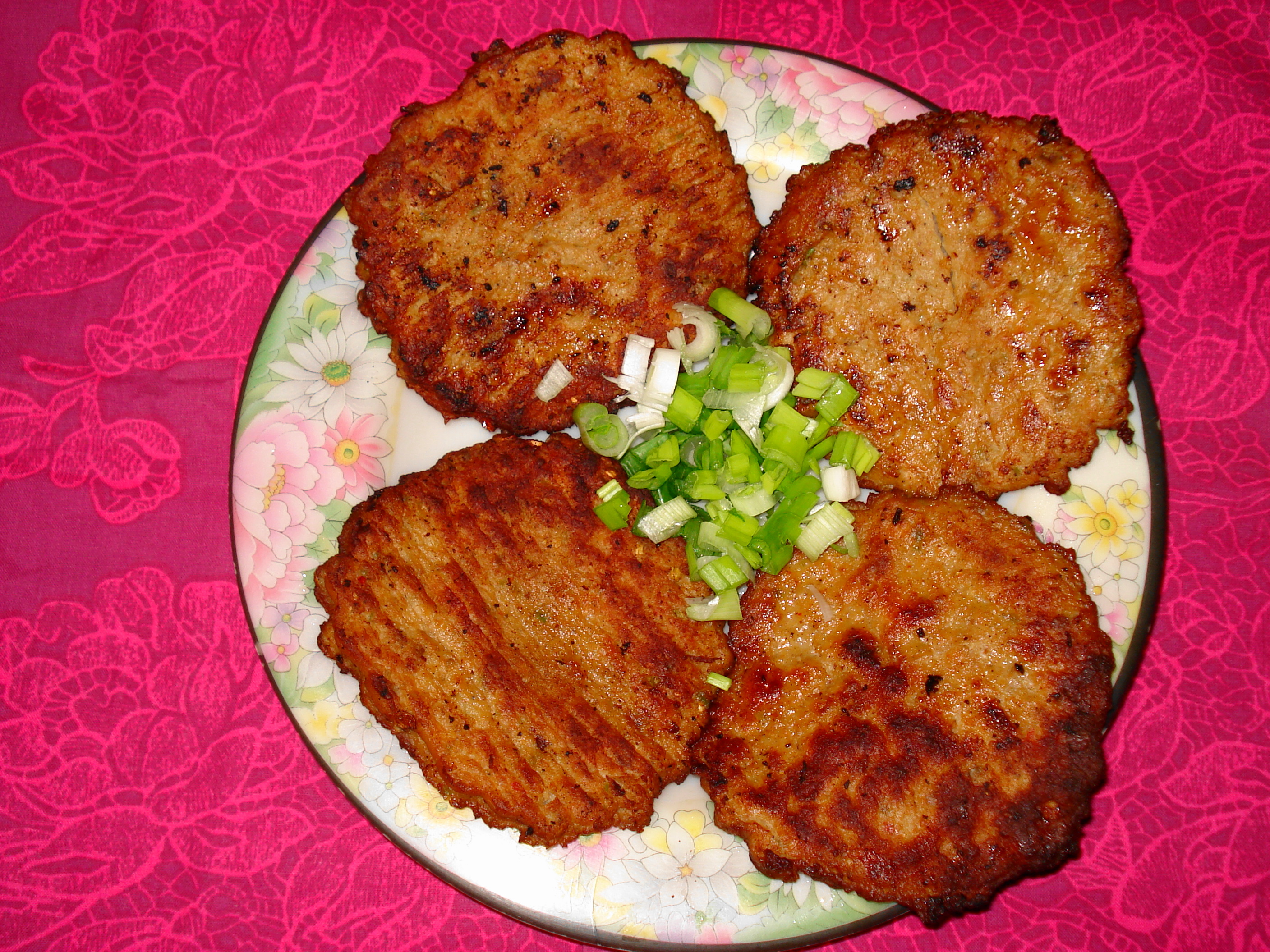 Photoreal photograph of the finished dish Chapli kabab (چپلی کباب), the actual plate from Pakistan, handmade ceramic, natural window light, shallow depth of field, no text, no logo, no people, Natural window light, ivory linen, handmade ceramic, shallow depth of field, no text, no logo, no watermark, fine-dining magazine photograph. Chapli kabab