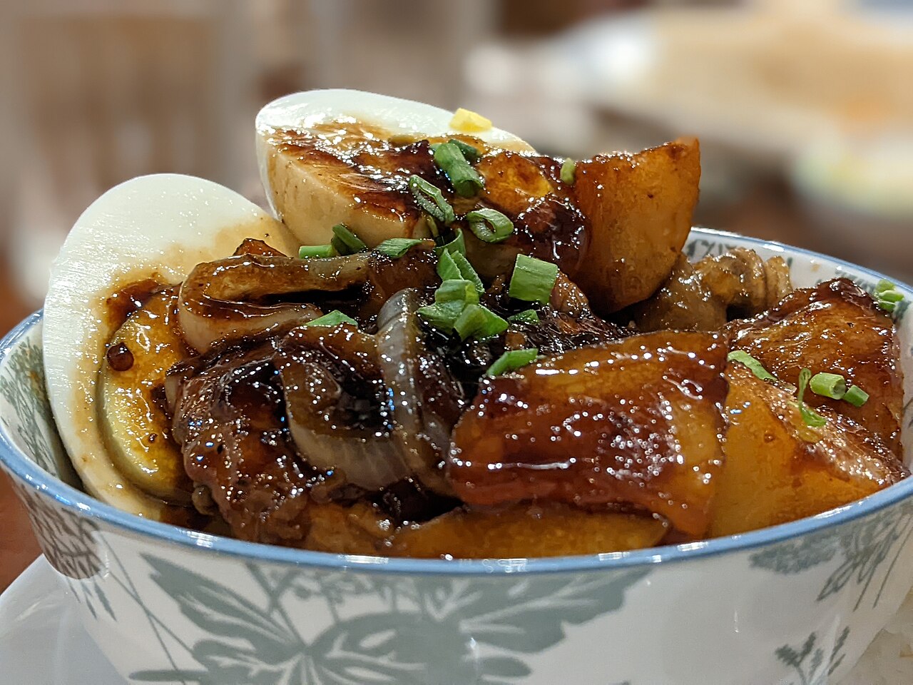 Photoreal photograph of the finished dish Chicken adobo (adobo), the actual plate from Philippines, handmade ceramic, natural window light, shallow depth of field, no text, no logo, no people, Natural window light, ivory linen, handmade ceramic, shallow depth of field, no text, no logo, no watermark, fine-dining magazine photograph. Chicken adobo