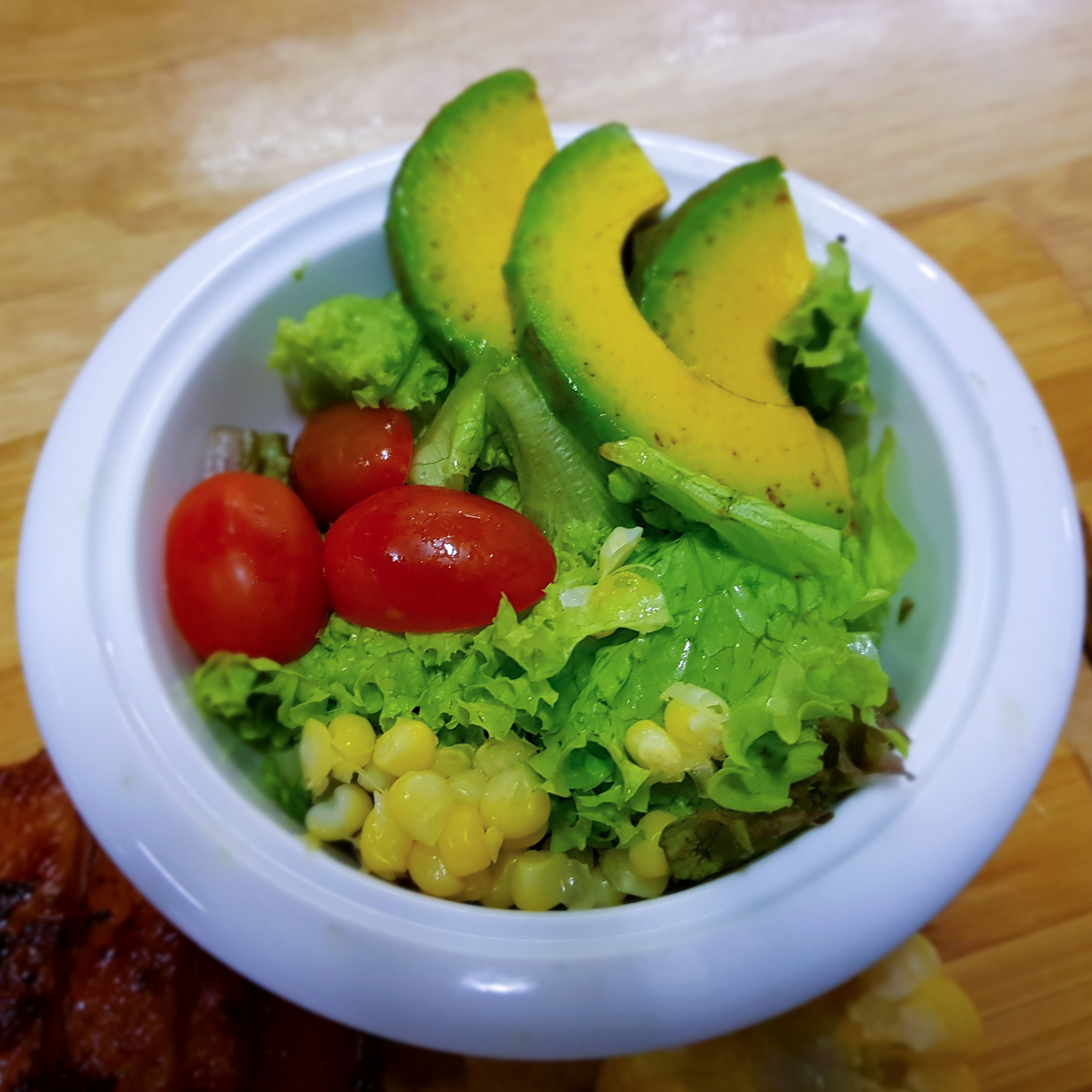Photoreal photograph of the finished dish Avocado salad (Salata), the actual plate from Uganda, handmade ceramic, natural window light, shallow depth of field, no text, no logo, no people, Natural window light, ivory linen, handmade ceramic, shallow depth of field, no text, no logo, no watermark, fine-dining magazine photograph. Avocado salad