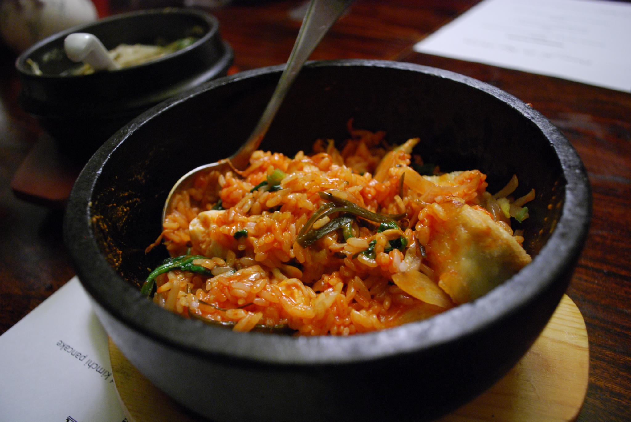 Bibimbap bowl with colorful vegetables, a fried egg, and gochujang on rice, Natural window light, ivory linen, handmade ceramic, shallow depth of field, no text, no logo, no watermark, fine-dining magazine photograph. Vegetable Bibimbap